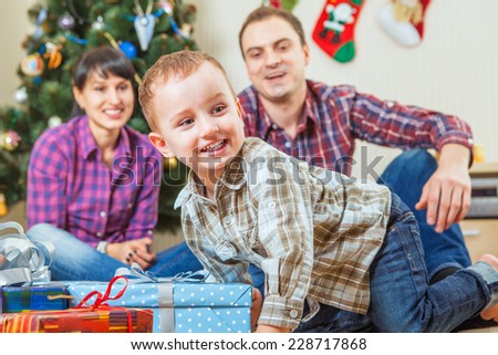 Happy little boy get a christmas gift from Santa