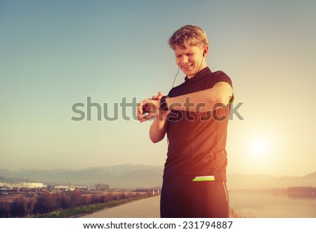 Runner starts his modern stopwatch before jogging