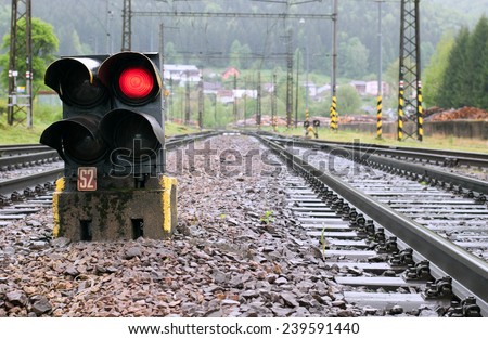 Railway tracks with red light semaphore