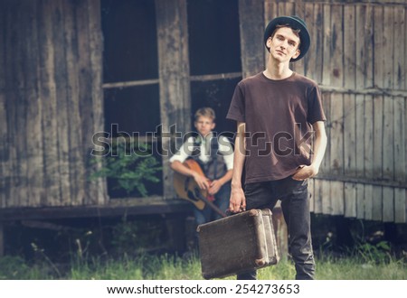 Young tramps guys near the lost house