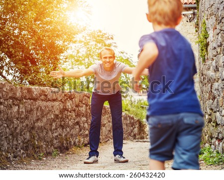 Son runs  to his father hugs