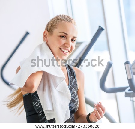 Attractive female with towel after Treadmill exercise