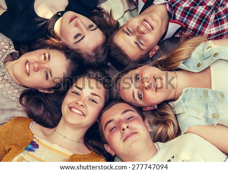 Teenage friends lying together in circle