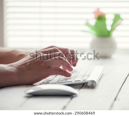 Woman hand on the PC keyboard