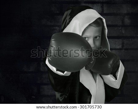 Boxing boy black and white portrait on dark grunge texture