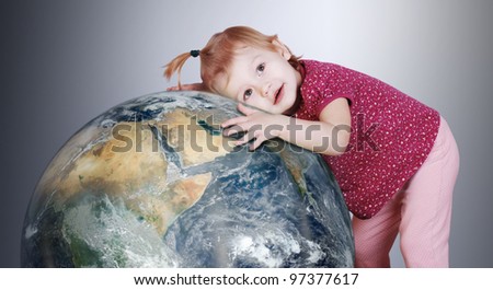 Little girl hugs with love the Earth globe
