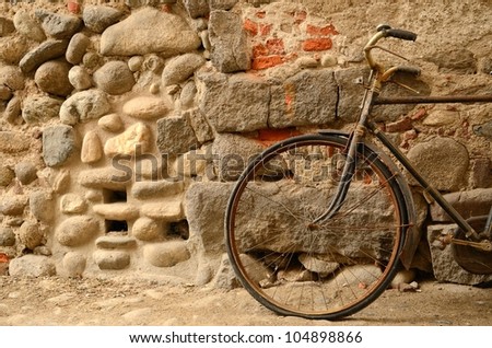 An old bicycle on the Candelo\'s medioeval street (Biella- Italy)