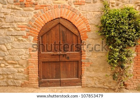 Old wooden door from medieval era, Ricetto di Candelo, Biella, Italy