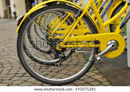 Yellow bicycles for rent in a parking spot, November 27, 2013 in Turin, Italy.