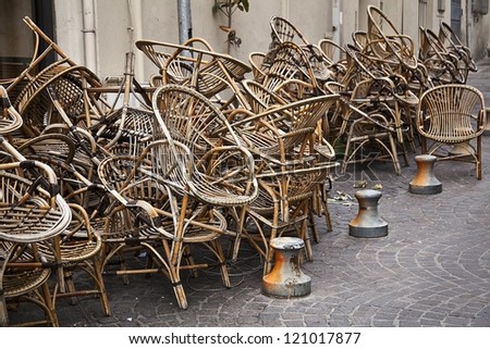 Wooden chairs piled up next to a restaurant in Aix-en Provence in the South of France.