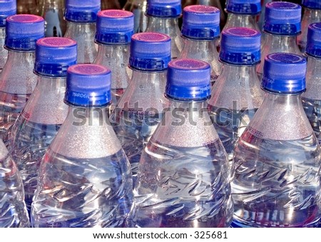 Close-up of plastic bottles of water  with blue and red caps.