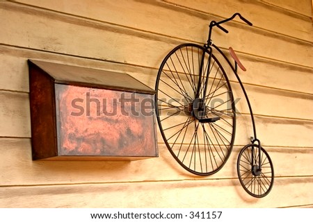 Old bicycle next to a metal mailbox hanging on a wall in New Hope, PA.