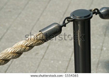 Rope barrier attached to a post with a snap hook.