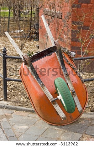 Wheel barrow chained to a fence in Washington Square Park in New York City.