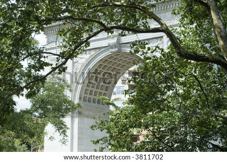 The arch framed by tree branches at Washington Square Park in Greenwich Village New York City.