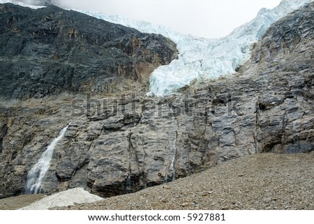 Hanging glacier on a mountain with a waterfall of melting ice below near Jasper Alberta Canada