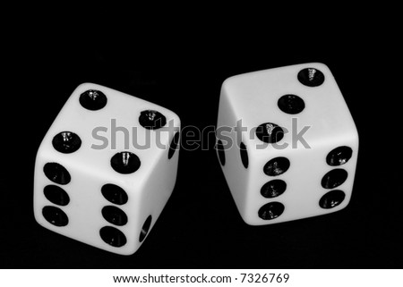Black and white image of a pair of dice thrown with the number seven.