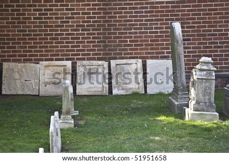 Old weather stone grave markers in a small cemetery in the historic section of Philadelphia, Pennsylvania.