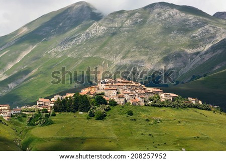 Beautiful mountain landscape with view on the village of Castelluccio, Umbria, Italy, well known for their world famous lentils fields.