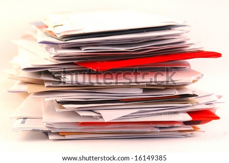 A pile of colorful letters and junk mail on a table isolated on white background