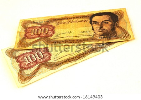 Old notes of one hundred Bolivares - the currency of the country Venezuela in South America - isolated on white background