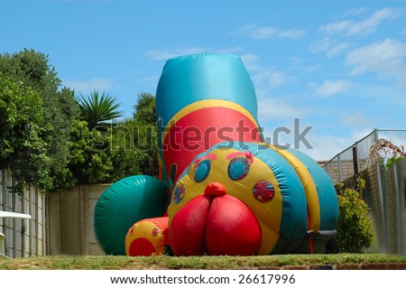 A colorful big bouncing castle for kids to jump on in the backyard outdoors