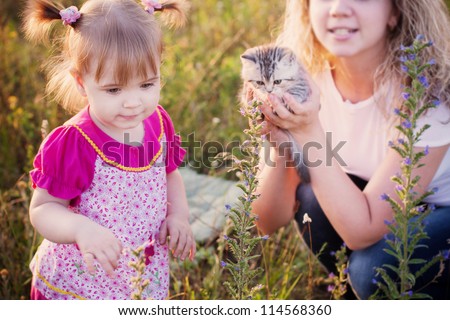little girl and mother with cats  outdoor