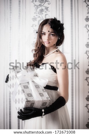 beautiful vintage woman holding gift