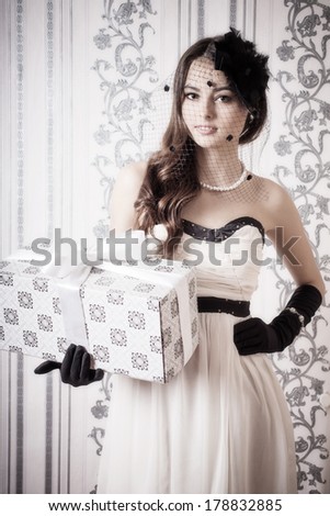 beautiful vintage woman holding gift