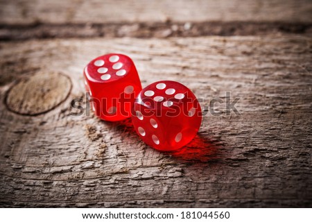 Pair of thrown red dices on old wooden table