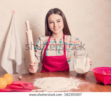 beautiful girl cooking cake in kitchen