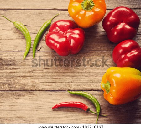 colored peppers on wooden background