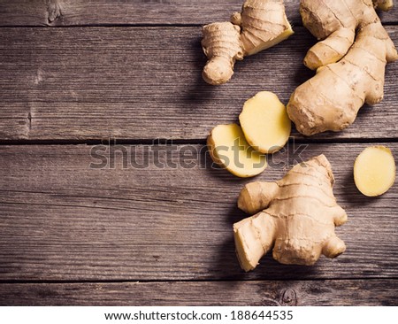 Ginger root sliced on wooden background