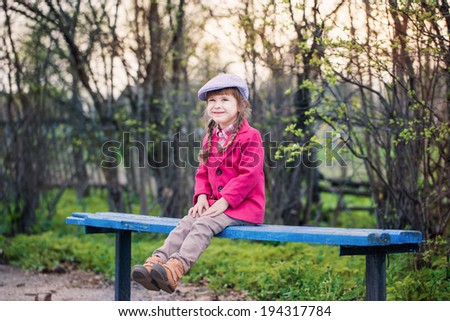 funny girl on bench in spring park