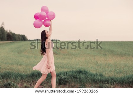 beautiful young women with pink balloons outdoor