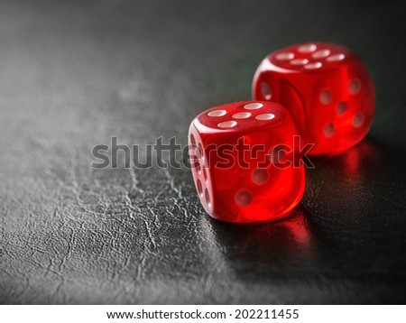 Pair of thrown red dices on black background