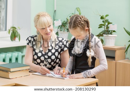 schoolgirl and teacher in classroom