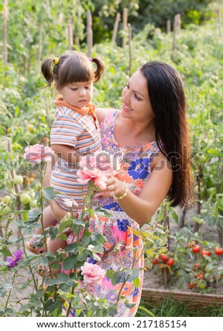 happy women and little child with roses outdoor