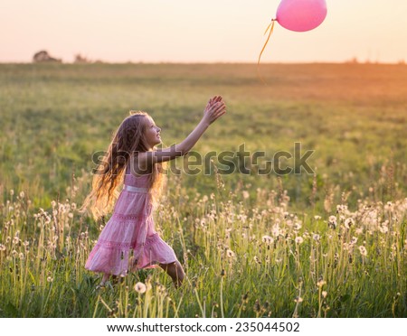 happy girl with pink balloon outdoor