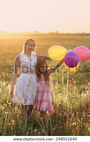 happy family with balloons outdoor