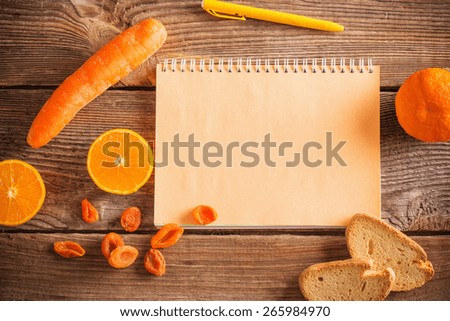Orange fruits and vegetables on wooden background