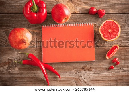 Red fruits and vegetables on wooden background