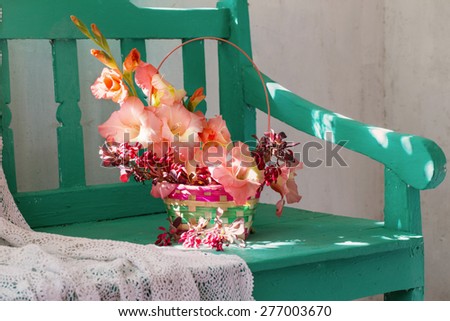 flowers in basket on bench indoor