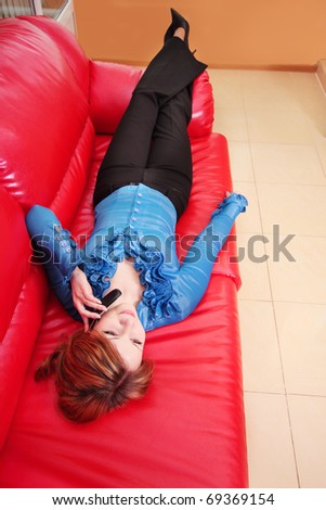 beautiful women on red sofa