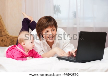 mother and baby with notebook