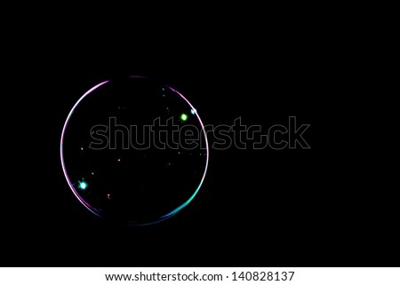 One soap bubble on a black background