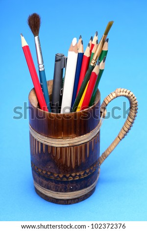 Pencil cup on blue background