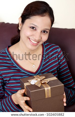 Indian woman holding a gift box