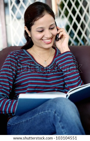 Happy student talking on cellphone