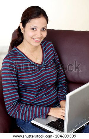 young beautiful Indian woman using laptop